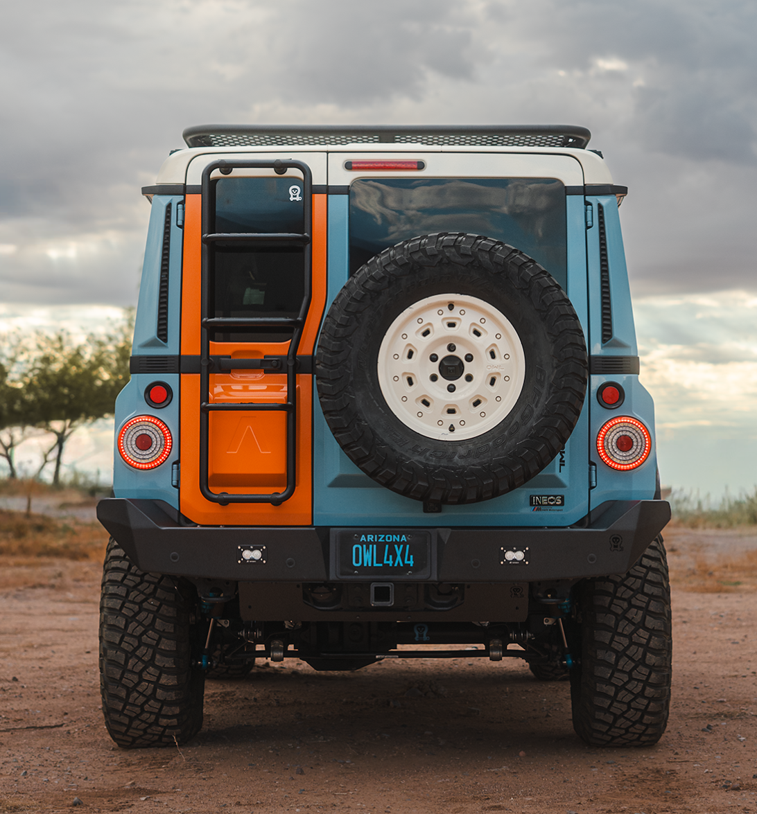 Rear view of INEOS Grenadier with high clearance steel rear bumper on rugged terrain