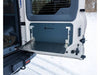 Folding tailgate table mounted on INEOS Grenadier vehicle door in snowy outdoor setting