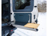 Folding Tailgate Table mounted on INEOS Grenadier with metal and wood surfaces in snowy outdoor setting