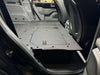 Explore Series second row seat delete plate system installed with large access hatches and flat surface in vehicle interior