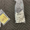 Sprinter curtain installation hardware and magnetic tabs in plastic bags on quilted surface
