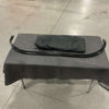 Black curved mounting rod and folded CLIMA-SHADE Showtime Sprinter Curtain on padded table in warehouse