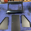 Components of a black powder-coated billet aluminum seat back locker for Sprinter vehicle displayed on a padded surface