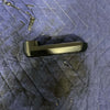 Black Grenadier hood release handle resting on a blue quilted surface