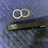 Grenadier Hood Release Handle with two metal washers on blue quilted fabric background