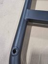Close-up of black powder-coated Sprinter tire carrier metal frame with welded bolt-on loop