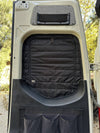 Insulated black Sprinter rear window cover with zippered access installed on van door