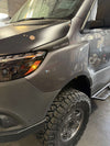 Sprinter van front with rugged trail fender flares and off-road tires installed