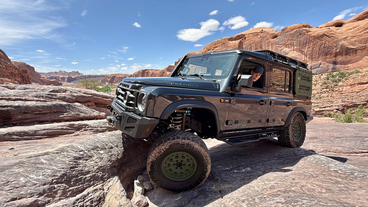 Owl Grenadier Steering Stabilizer installed on off-road Grenadier vehicle driving on rocky terrain