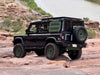 INEOS Grenadier off-road vehicle with high clearance steel rear bumper on rocky terrain