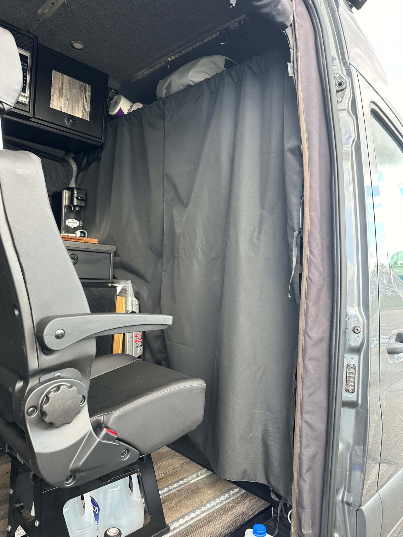Stealth Blackout Curtain installed in van dividing front seat area for privacy and heat blockage
