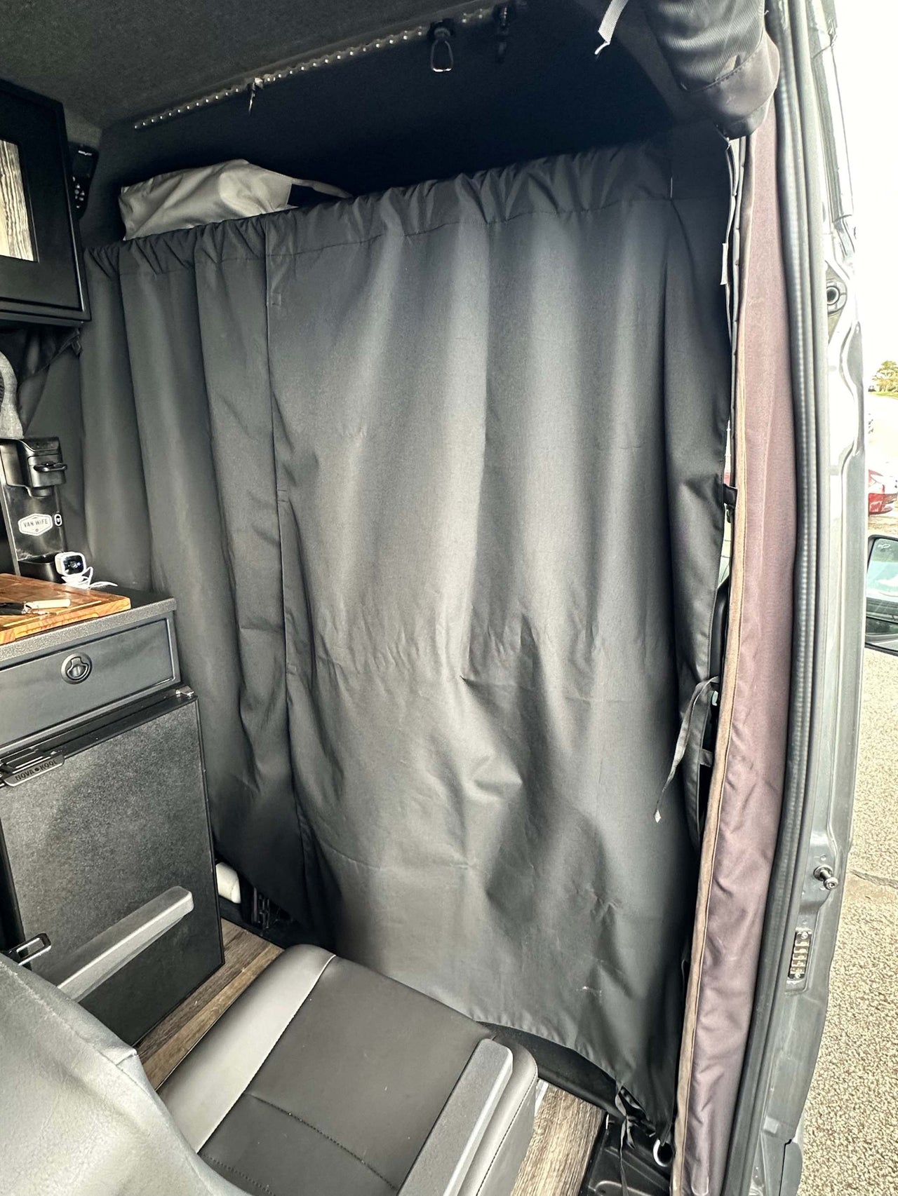Stealth Blackout Curtain installed inside a van blocking light and providing privacy for urban camping