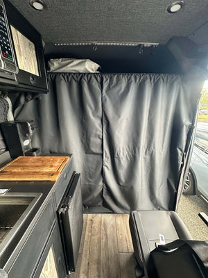 Stealth Blackout Curtain installed in van to block light and heat, providing privacy for urban camping.