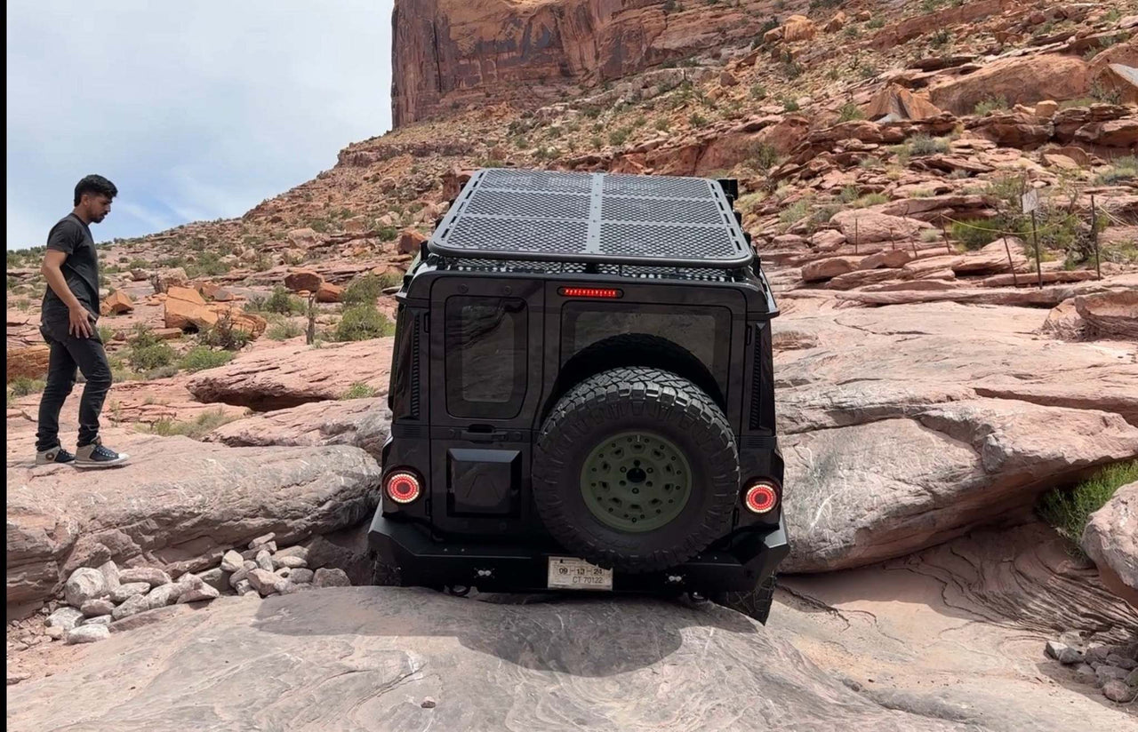 INEOS Grenadier off-road vehicle with high clearance rear bumper climbing rocky terrain