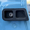 Close-up of rear door washer installed on blue INEOS Grenadier door panel