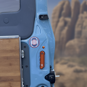 Rear door washers installed on blue INEOS Grenadier rear door protecting paint and securing rubber bumpers