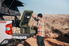 Man organizing 105L Lid Organizer attached inside rugged case lid on truck tailgate in desert
