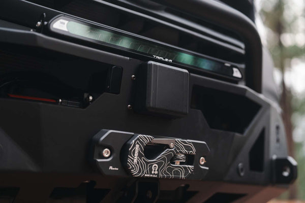 Close-up of Owl x VanCraft Wasatch Halo Sprinter van front winch with topographic design