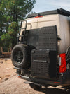 Owl x VanCraft Wasatch Halo Sprinter van rear with spare tire and accessory mounts in outdoor setting
