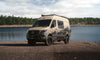 Owl x VanCraft Wasatch Halo Sprinter van with mountain graphics parked by lake in wilderness