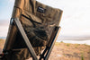 Tan ergonomic camp chair with mesh storage pocket outdoors
