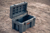 55L rugged durable LLDPE case with lockable latches and gasket seal open on dirt ground