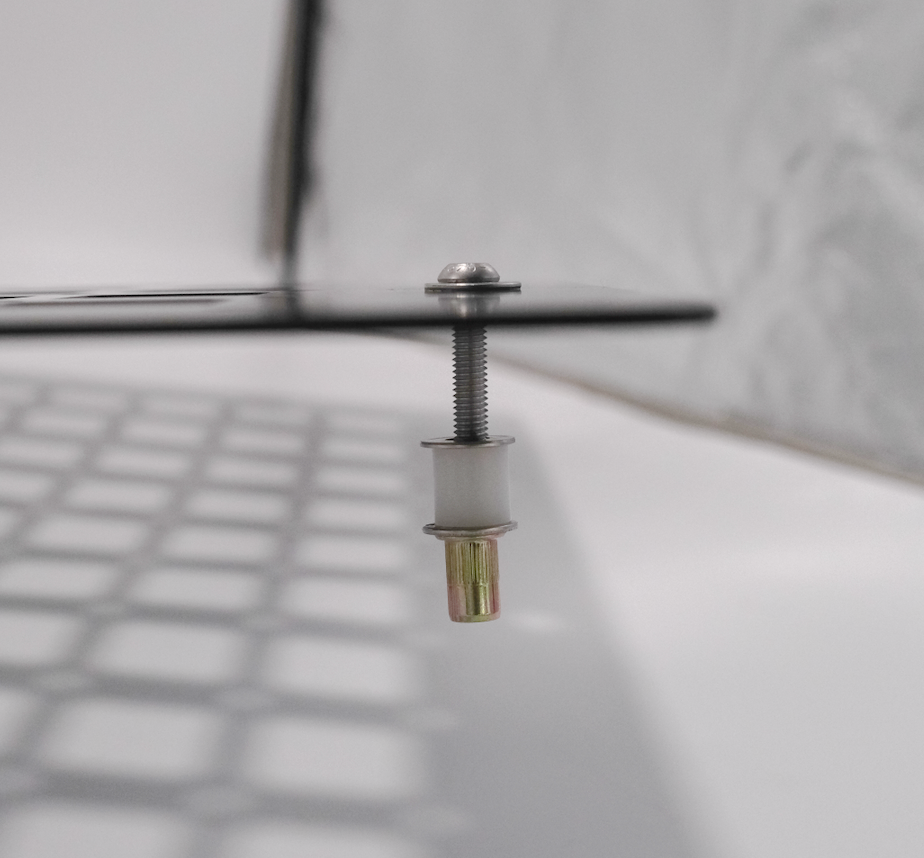Close-up of stainless steel M6 hardware with rivnut and nylon spacer for Rear Door Modular MOLLE Panels on Ram Promaster.