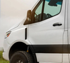 White Sprinter van with black Sprinter Trail Fender Flares installed on front wheel arches for rugged, widened tire coverage.