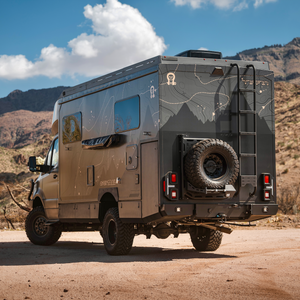 OTX Tiffin Open Trail adventure van parked in desert landscape with rugged mountains in background