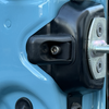 Close-up of rear door washer and bumper on a blue INEOS Grenadier vehicle door