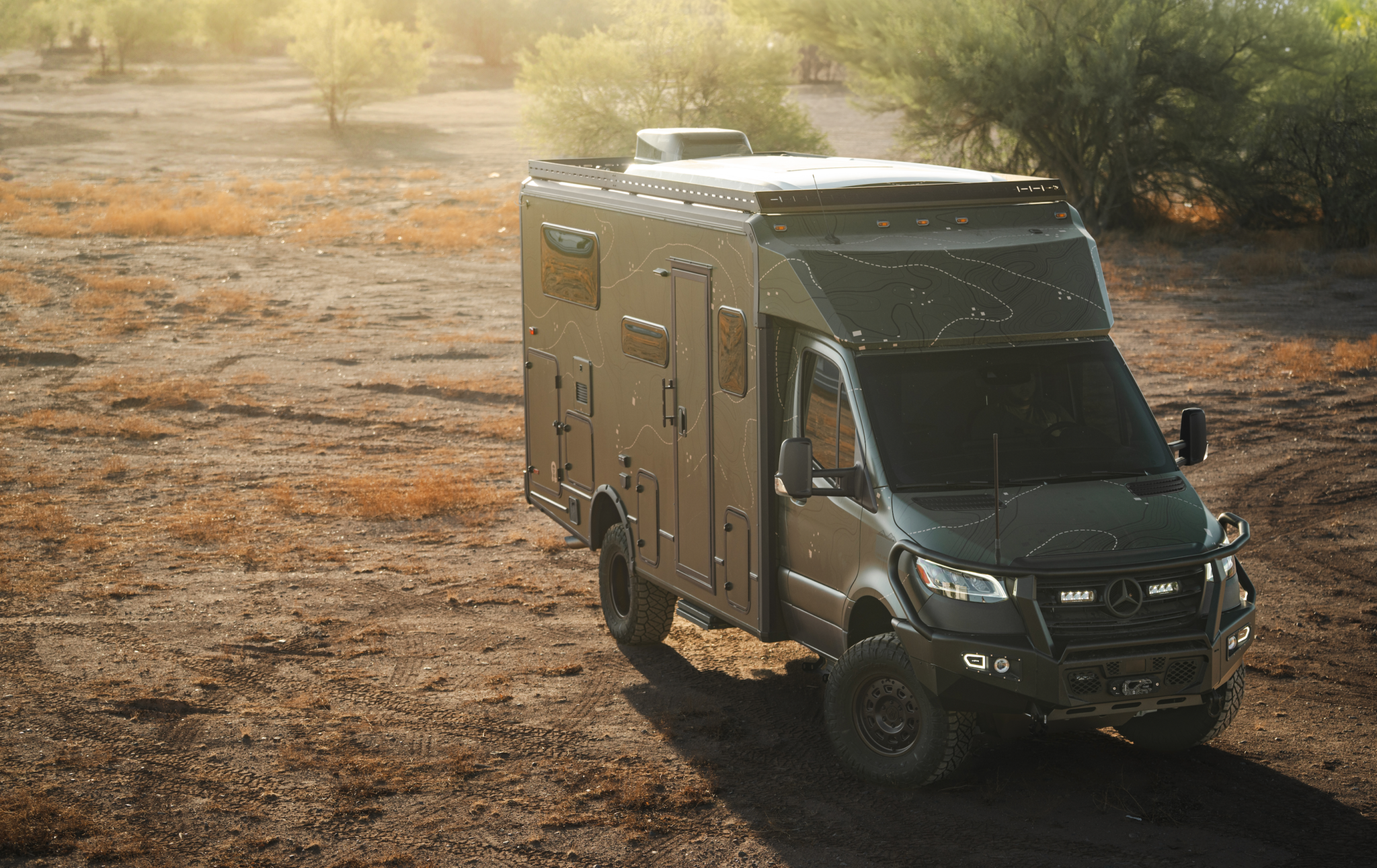 Winnebago Ekko RV equipped with aftermarket Ekko Roof Rack Teton Edition in rugged outdoor setting