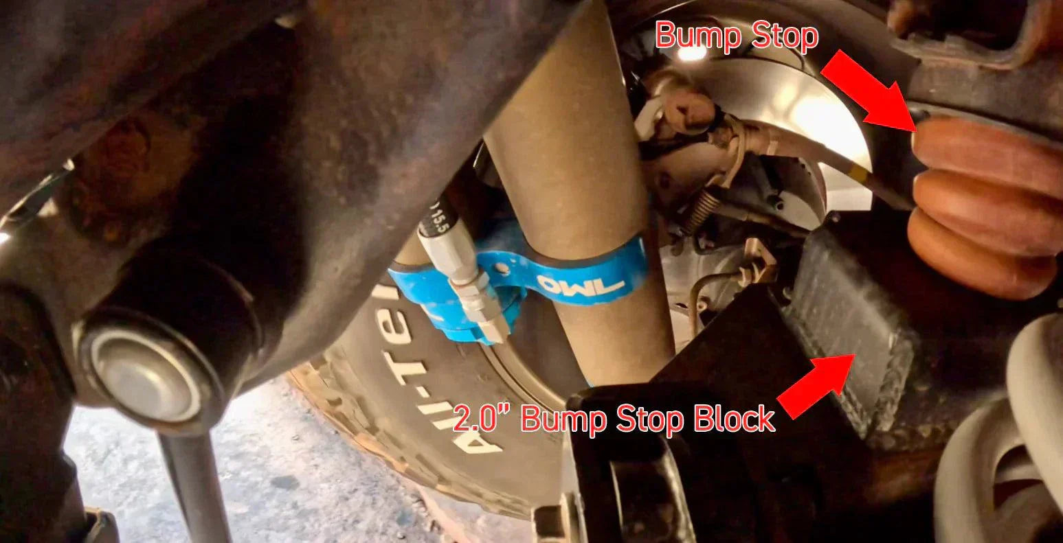 Grenadier Suspension - Close-up of Owl 4" Lift TrailFlo Suspension with labeled bump stop and 2.0" bump stop block on INEOS vehicle suspension system