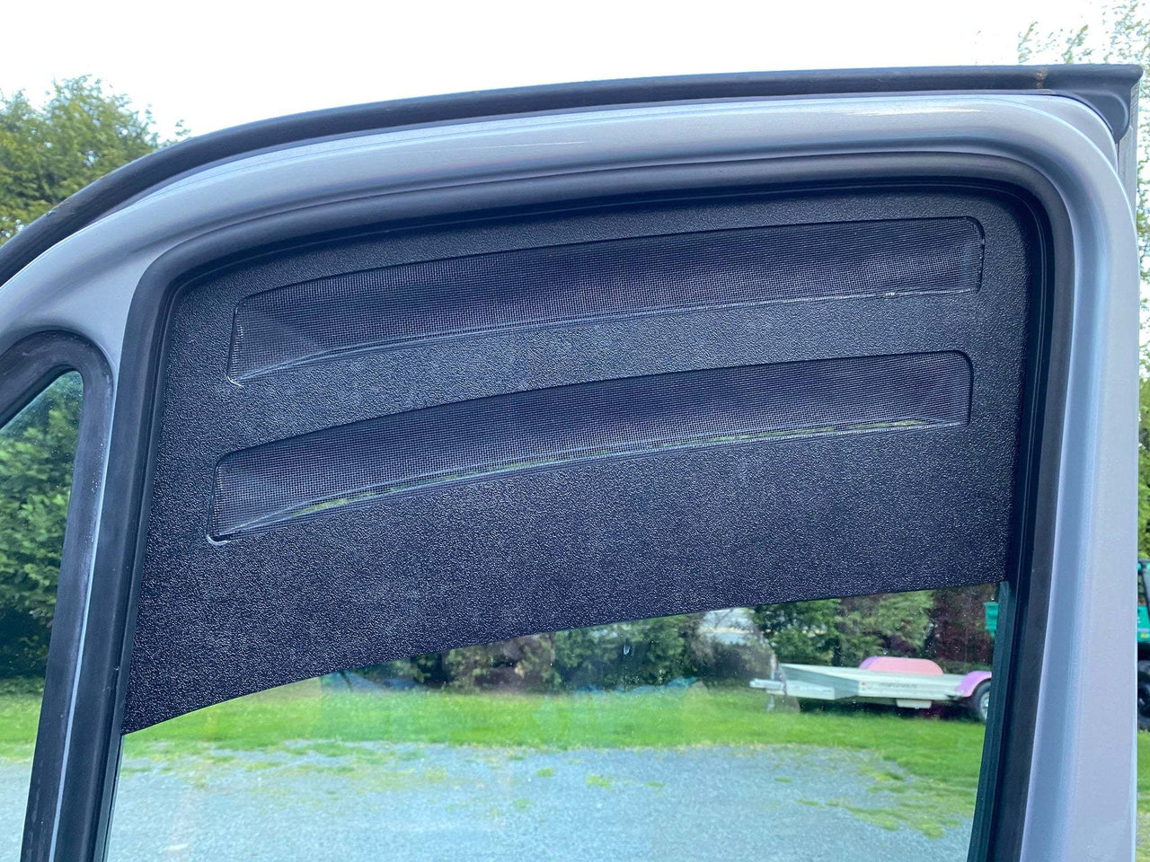 Bug Barrier front window vent installed on Sprinter van door for insect and rain protection with airflow