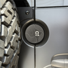 Machined aluminum rear door emblem with laser engraving for Sprinter, designed to fit oversized tires and attach to factory mounting holes.