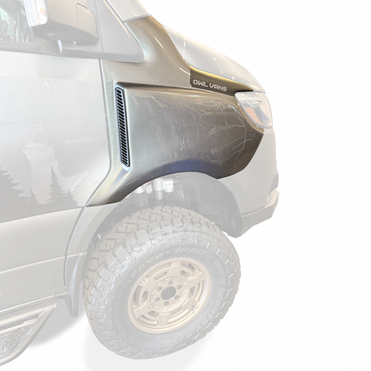 Sprinter van with wide rugged trail fender flares on front haunches covering extended tires