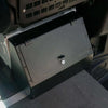 Black billet aluminum seat back locker with lock installed behind Sprinter front seat for secure storage