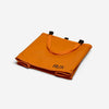 Orange RUX 25L bag folded with handles and logo visible