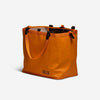 Orange RUX 25L Bag with handles, versatile and easy to pack for convenient storage.