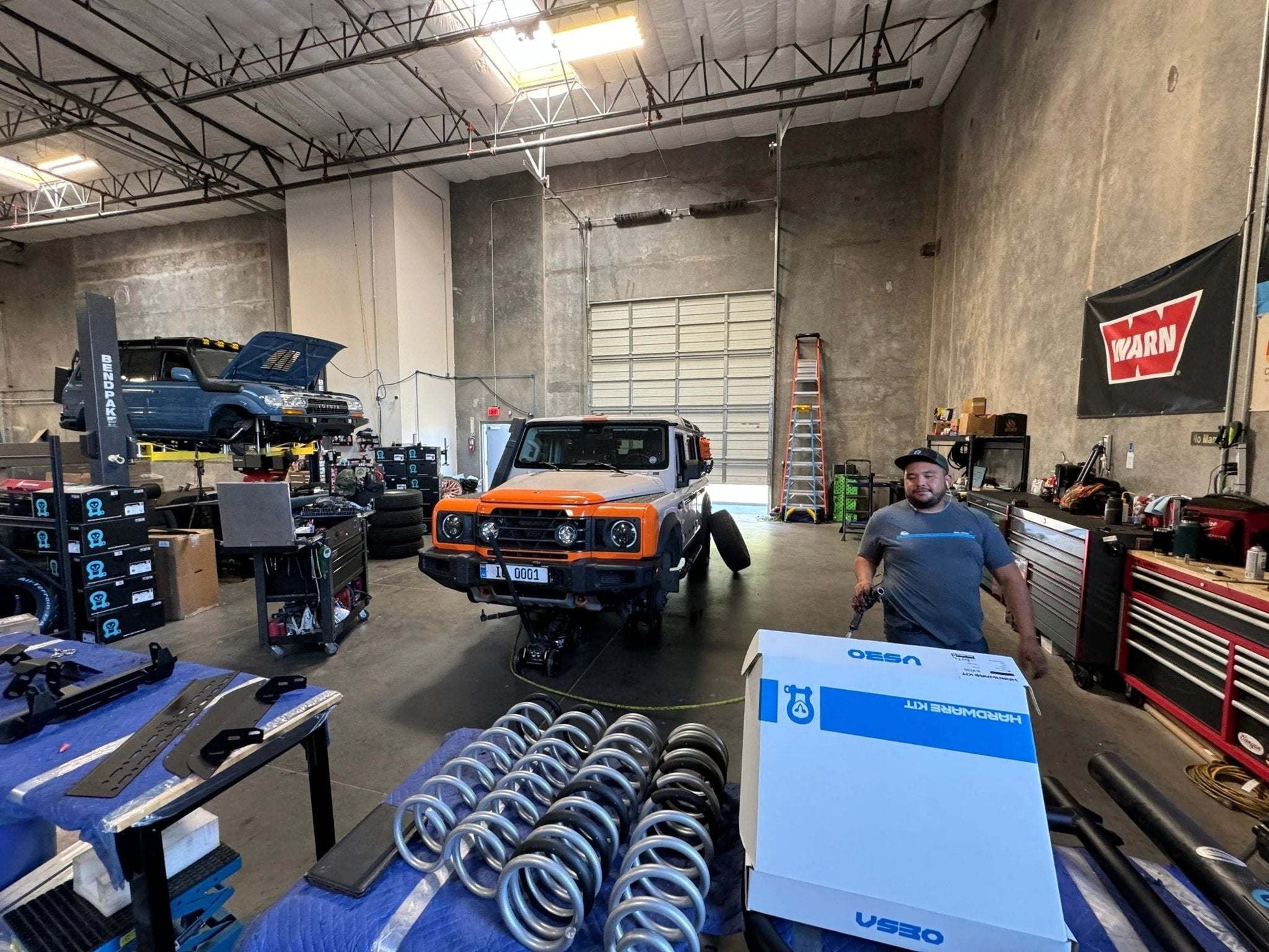 Eibach Pro Lift Kit 2.5" for INEOS Grenadier on display in garage.