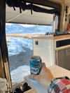 F45s Awning providing shade over an outdoor camper setup with a scenic snowy mountain view.