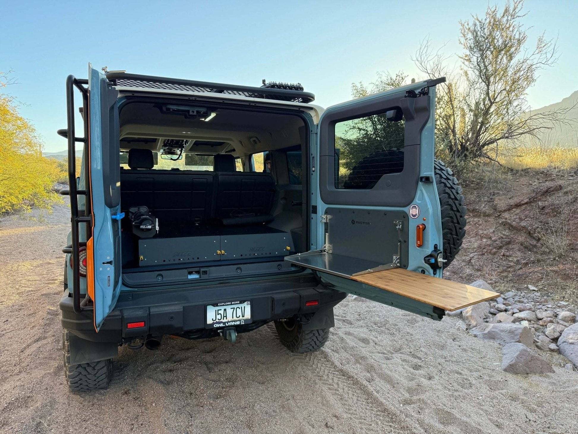 Folding Tailgate Table for INEOS Grenadier in outdoor setting, enhancing vehicle utility and durability.