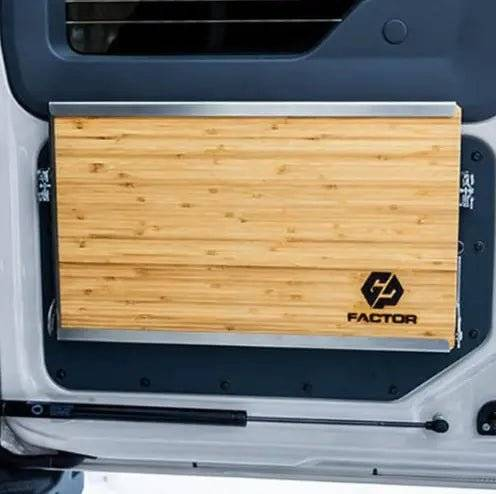 Folding Tailgate Table for INEOS Grenadier mounted on vehicle interior.