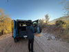 Folding Tailgate Table for INEOS Grenadier installed on vehicle in outdoor setting.