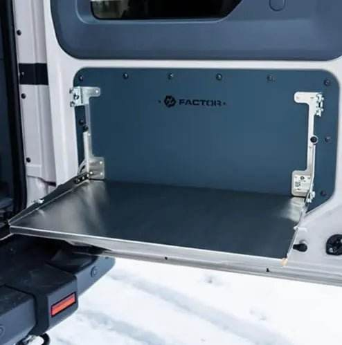 Folding tailgate table installed on INEOS Grenadier for enhanced utility and durability.