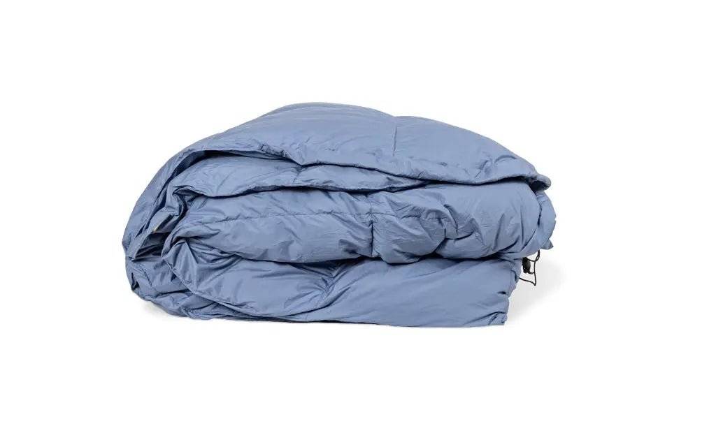 Blue down comforter designed for durability and adventure use.