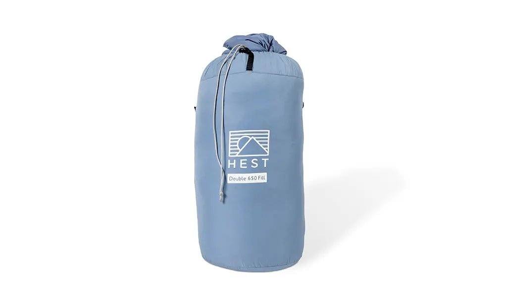 HEST down comforter in blue compression sack for durable outdoor adventure use