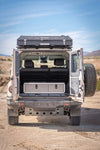 Grenadier Explore Series Side X Side Drawer Module installed in SUV rear cargo area with desert landscape background