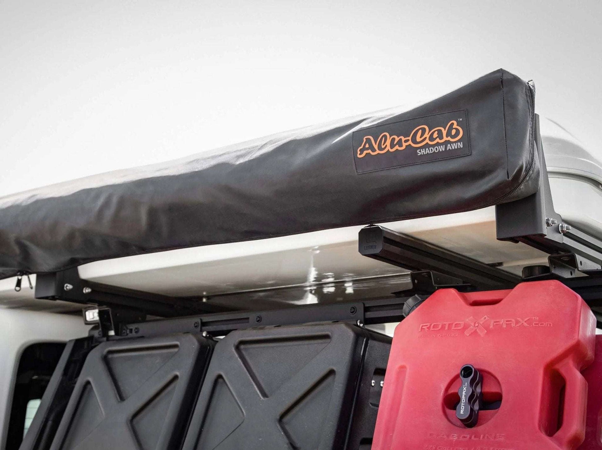HD Awning Bracket for INEOS Grenadier supporting expedition awning on roof rack.