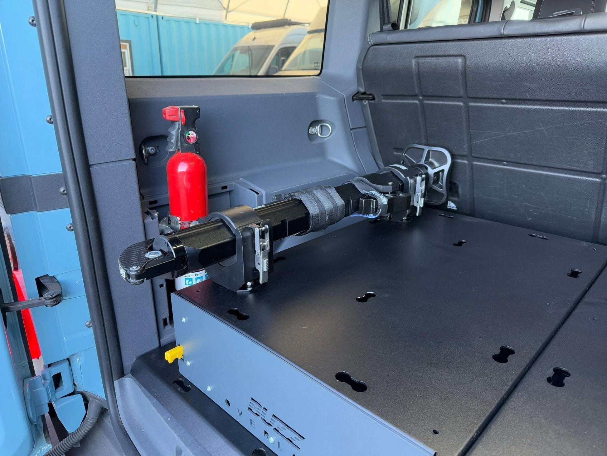 Hydraulic jack with mounts in INEOS Grenadier interior setup.