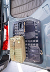 Rear Door Modular MOLLE storage panel mounted on Mercedes Sprinter rear door with attached tactical pouches for organized gear storage.